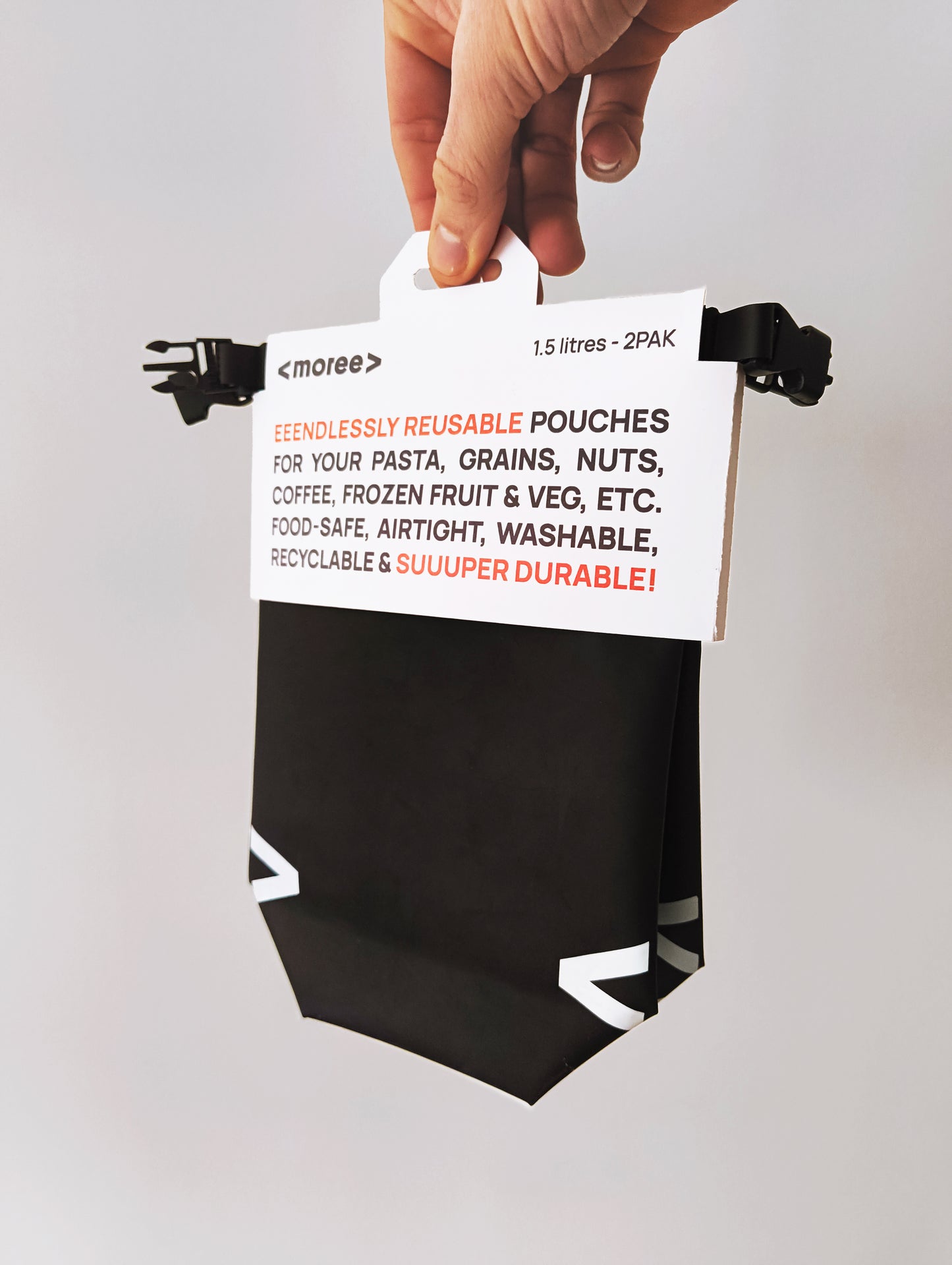 Reusable food pouch held by a hand with text on a white background